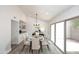Modern dining room with glass table and access to backyard at 916 S Melody Ln, Tempe, AZ 85281