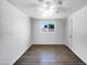 Simple bedroom with neutral walls and wood-look tile floors at 2236 E Nancy Ln, Phoenix, AZ 85042