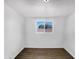 Simple bedroom with tile floors and a window offering a view of the neighborhood at 2236 E Nancy Ln, Phoenix, AZ 85042