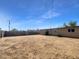 Large, open backyard with dirt and a fence at 2236 E Nancy Ln, Phoenix, AZ 85042