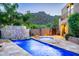 Luxury pool with spa and waterfall feature; expansive patio with mountain views at 36631 N Peaceful Pl, Carefree, AZ 85377