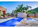 Resort-style backyard oasis with a large pool, spa, fire pit, and lounge chairs at 36631 N Peaceful Pl, Carefree, AZ 85377