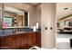 Elegant bathroom with dark wood vanity and a view into the bedroom at 36631 N Peaceful Pl, Carefree, AZ 85377