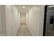 Light hallway with wood-look flooring at 46137 W Starlight Dr, Maricopa, AZ 85139