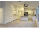 Bright kitchen with white cabinets, island, and wood floors at 46137 W Starlight Dr, Maricopa, AZ 85139