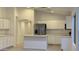 Modern kitchen with white cabinets, quartz countertops, and stainless steel appliances at 46137 W Starlight Dr, Maricopa, AZ 85139
