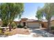 Tan house with tile roof, two-car garage, and landscaping at 46137 W Starlight Dr, Maricopa, AZ 85139
