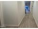 Bright hallway with wood-look flooring at 46137 W Starlight Dr, Maricopa, AZ 85139