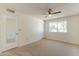 Spacious bedroom with neutral carpeting and ceiling fan at 10342 W Talisman Rd, Sun City, AZ 85351