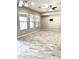 Living room with tile flooring, multiple windows, and ceiling fan at 18206 W Sells Dr, Goodyear, AZ 85395
