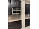 Kitchen with built-in microwave and dark cabinets at 18206 W Sells Dr, Goodyear, AZ 85395