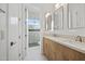 Modern bathroom with double vanity, large mirror, and a walk-in shower at 7147 E Wilderness Trl, Gold Canyon, AZ 85118