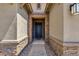 Inviting entryway with stone accents and dark door at 32269 N 133Rd Dr, Peoria, AZ 85383