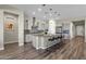 Modern kitchen with island, stainless steel appliances, and hardwood floors at 32269 N 133Rd Dr, Peoria, AZ 85383