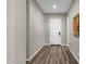 Bright and airy entryway with wood-look floors and neutral walls at 32269 N 133Rd Dr, Peoria, AZ 85383
