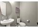 Clean and updated bathroom with pedestal sink and toilet at 32269 N 133Rd Dr, Peoria, AZ 85383