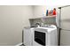 Convenient laundry room with washer, dryer, and shelving at 32269 N 133Rd Dr, Peoria, AZ 85383