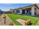 Landscaped backyard with artificial turf and a wooden bench at 32269 N 133Rd Dr, Peoria, AZ 85383