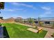 Spacious backyard with artificial turf and cornhole game at 32269 N 133Rd Dr, Peoria, AZ 85383