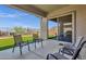 Covered patio with seating overlooking a grassy backyard at 32269 N 133Rd Dr, Peoria, AZ 85383