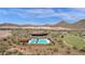 Aerial view of community pool, clubhouse, and surrounding desert landscape at 32269 N 133Rd Dr, Peoria, AZ 85383