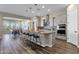 Modern kitchen with island, stainless steel appliances, and breakfast bar at 32269 N 133Rd Dr, Peoria, AZ 85383