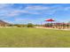Large grassy playground with play structures and shade at 32269 N 133Rd Dr, Peoria, AZ 85383