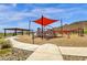Modern playground with shade structure and play equipment at 32269 N 133Rd Dr, Peoria, AZ 85383