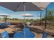 Blue patio tables and chairs near a court at 25915 N 23Rd Ave, Phoenix, AZ 85085