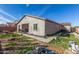 Rear view of house with covered patio and backyard at 46029 W Keller Dr, Maricopa, AZ 85139