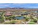 Aerial view of community with lake, clubhouse, and tennis courts at 17938 W Tanglewood Dr, Goodyear, AZ 85338