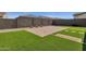 Landscaped backyard with artificial turf and a brick paver patio at 17938 W Tanglewood Dr, Goodyear, AZ 85338