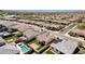 Aerial view of homes, pools, and a lake in a sunny neighborhood at 17938 W Tanglewood Dr, Goodyear, AZ 85338