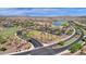 Aerial view of community amenities including a lake, clubhouse and park at 17938 W Tanglewood Dr, Goodyear, AZ 85338