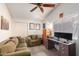 Cozy bedroom with a ceiling fan, window, and built-in desk at 947 W Barcelona Dr, Gilbert, AZ 85233