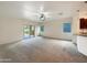 Living room with carpet flooring and access to the backyard at 432 W Flame Tree Ave, San Tan Valley, AZ 85140