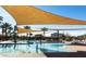 Relaxing community pool with shade sails and water features at 432 W Flame Tree Ave, San Tan Valley, AZ 85140