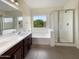 Clean bathroom featuring a soaking tub, shower, and double vanity at 432 W Flame Tree Ave, San Tan Valley, AZ 85140