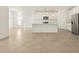 Modern kitchen with white cabinets, island, and stainless steel appliances at 37375 W Patterson St, Maricopa, AZ 85138