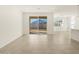 Sunlit living room with tile floors and sliding glass doors at 37375 W Patterson St, Maricopa, AZ 85138
