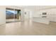 Bright kitchen with island, white cabinets, and sliding door to backyard at 37375 W Patterson St, Maricopa, AZ 85138
