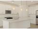 White shaker cabinets, quartz countertops, and kitchen island at 37375 W Patterson St, Maricopa, AZ 85138