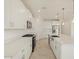 Modern kitchen with white cabinets, island, and stainless steel appliances at 37375 W Patterson St, Maricopa, AZ 85138