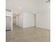 Bright living room with tile floors and sliding glass door access to backyard at 37375 W Patterson St, Maricopa, AZ 85138