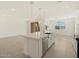 Modern kitchen island, stainless steel appliances, and tile flooring at 37375 W Patterson St, Maricopa, AZ 85138