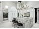 Luxury kitchen features a large marble island, high end appliances, and wine storage at 19452 N 98Th Pl, Scottsdale, AZ 85255