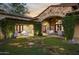 Charming stone patio with seating area and lush landscaping at 19452 N 98Th Pl, Scottsdale, AZ 85255