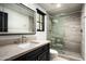 Modern bathroom with a frameless glass shower and dark vanity at 19452 N 98Th Pl, Scottsdale, AZ 85255