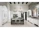 Open concept kitchen with marble island, stainless steel appliances, and white cabinetry at 19452 N 98Th Pl, Scottsdale, AZ 85255