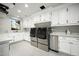 Bright laundry room with white cabinets and stainless steel appliances at 19452 N 98Th Pl, Scottsdale, AZ 85255